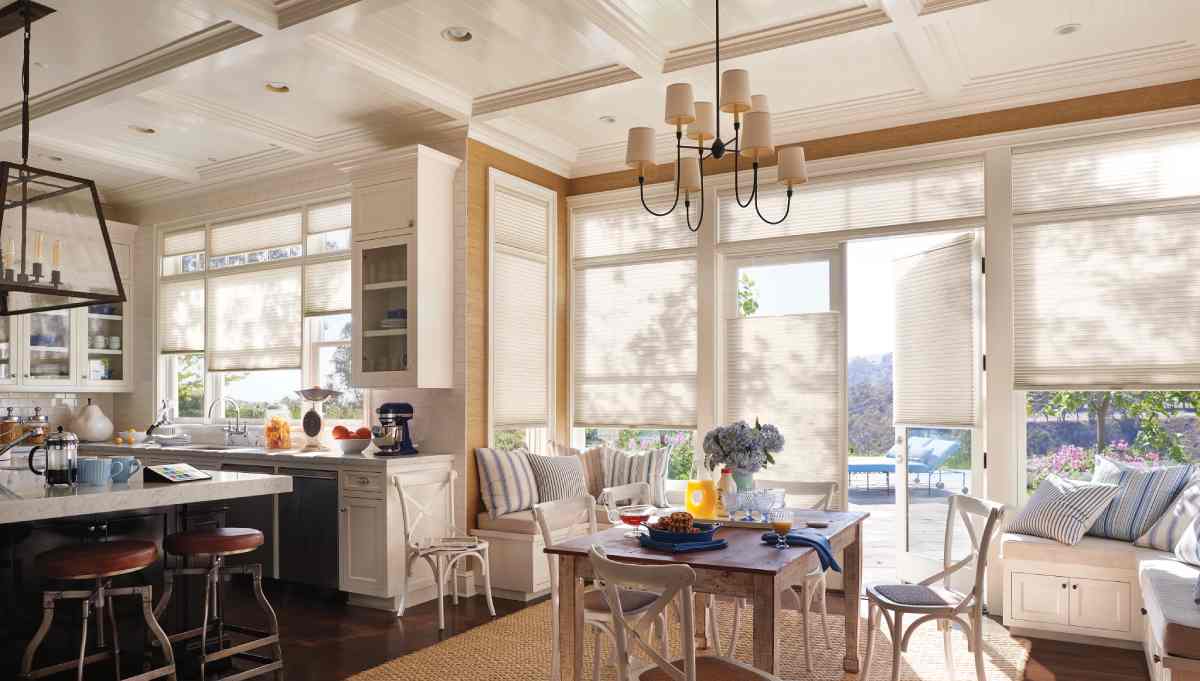Products & Services 5 Hunter Douglas cellular shades on a patio door in a furnished kitchen near Chicagoland, IL.